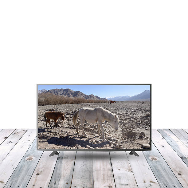 istock modern monitor LCD on wooden table with white copy space 615479952