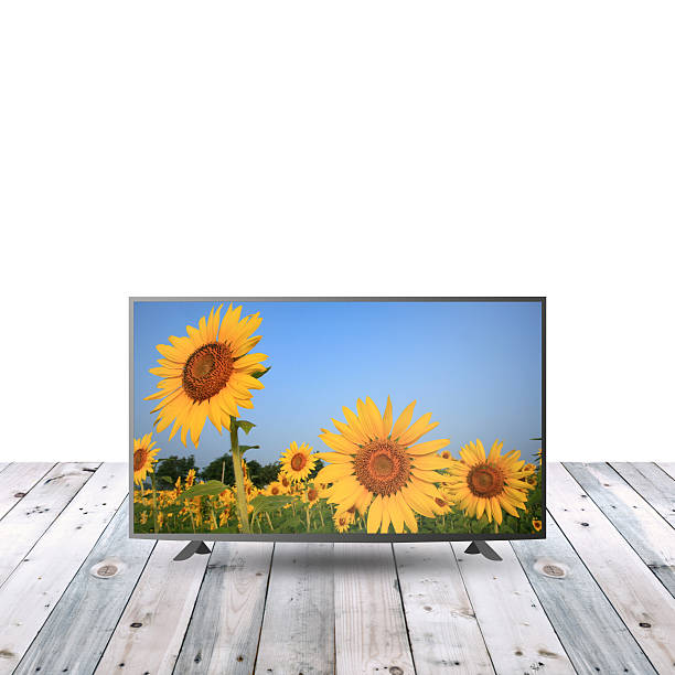 istock modern monitor LCD on wooden table with white copy space 615480140