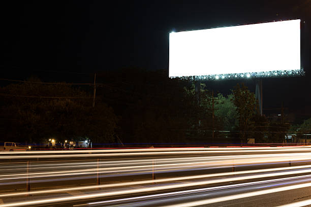 istock Large billboard blank on city night with light trails for 615480294