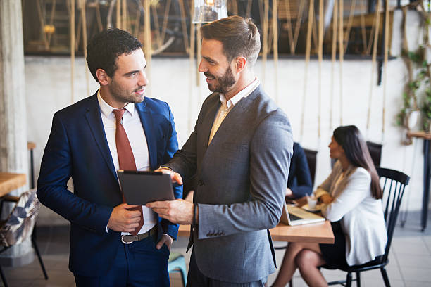 istock Two young businessmen discussing business strategy using digital tablet 615480660
