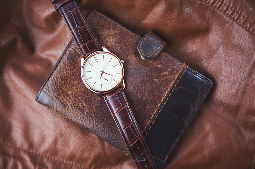 watch on wallet on  leather background