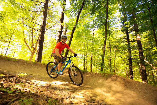 istock Young Man Mountain Biking in Forest Trail 615483294