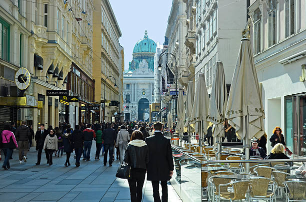 Austria, Vienna Vienna, Austria - March 27, 2016: Crowd of unidentified people on pedestrian zone Kohlmark with Hofburg in the inner city kohlmarkt street photos stock pictures, royalty-free photos & images