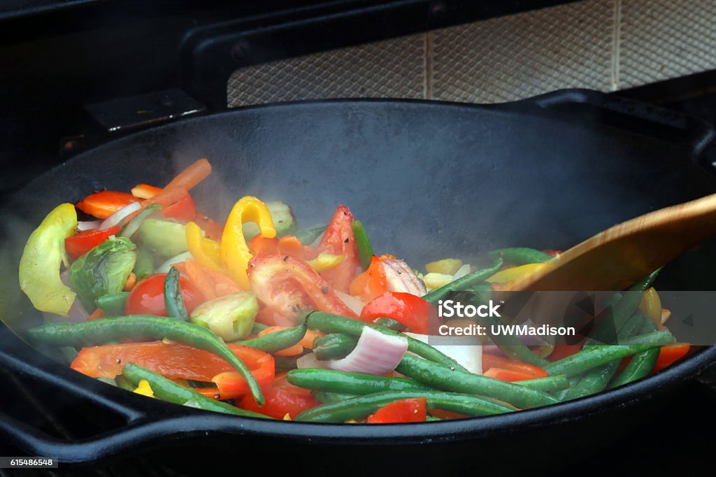 Wok stir fry Close up photo of wok stir fry covered by smoke in a grill. A wok with assorted chopped vegetables such as carrots, beans, red and yellow pepper, onion and brussels sprouts for vegetarian healthy eating in a cooking process. Stir-Fried Stock Photo Wok stir fry Close up photo of wok stir fry covered by smoke in a grill. A wok with assorted chopped vegetables such as carrots, beans, red and yellow pepper, onion and brussels sprouts for vegetarian healthy eating in a cooking process. Stir-Fried Stock Photo