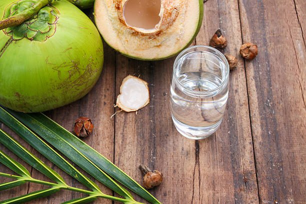 istock Fresh Coconut Water Drink  on wooden  background 615487246