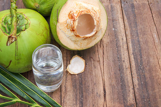 istock Fresh Coconut Water Drink  on wooden  background 615487254