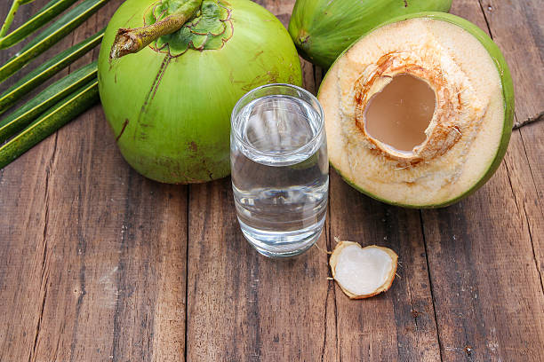 istock Fresh Coconut Water Drink  on wooden  background 615487256