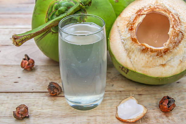 istock Fresh Coconut Water Drink  on wooden  background 615487296