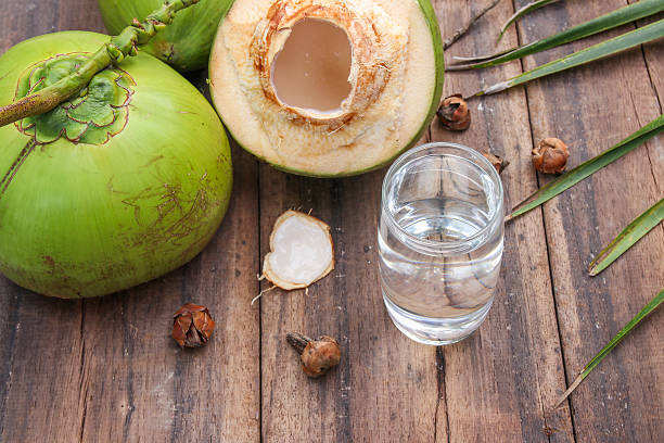 istock Fresh Coconut Water Drink  on wooden  background 615487326