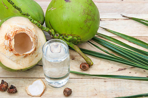istock Fresh Coconut Water Drink  on wooden  background 615487350