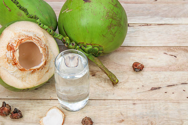 istock Fresh Coconut Water Drink  on wooden  background 615487384