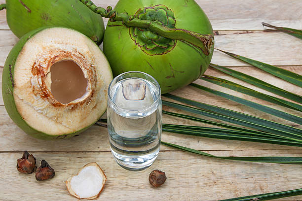 istock Fresh Coconut Water Drink  on wooden  background 615487396