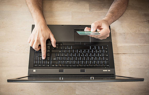 istock Hands holding credit card and using laptop 615488878
