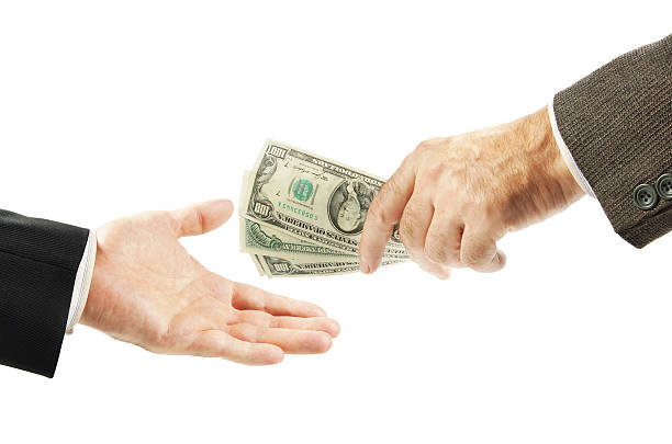 istock One man gives money to another 615489062