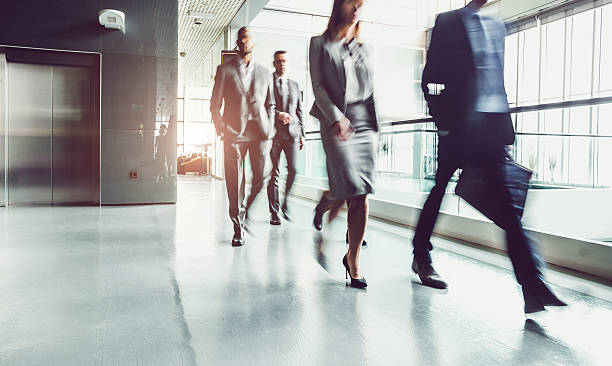 istock Business People Walking Through the Corridor 615489526