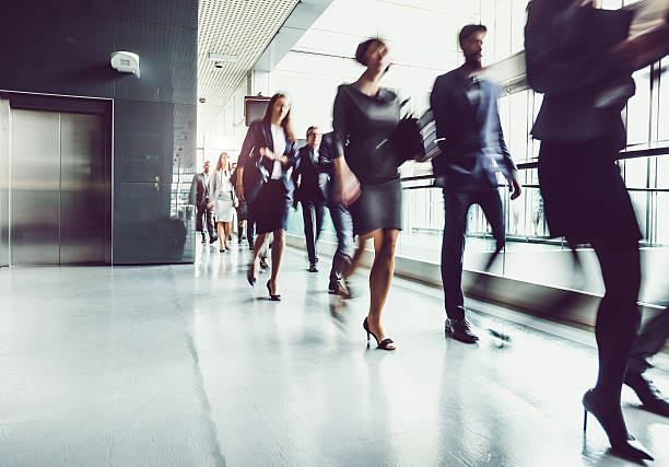 istock Business People Walking Through the Corridor 615489606