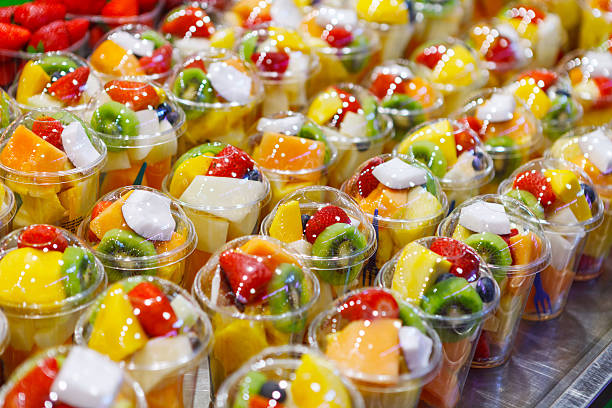 istock Fruit Salad arranged in plastic cups on a market 615490058