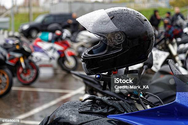 Moto Helmet On Motorcycle Handlebars Stock Photo - Download Image Now - Rain, Motorcycle, Crash Helmet