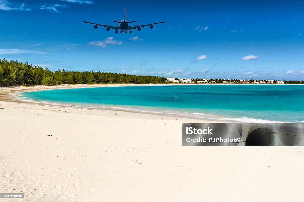 An Airplane approaching Exuma (Bahamas) over Emerald Bay Airplane Stock Photo