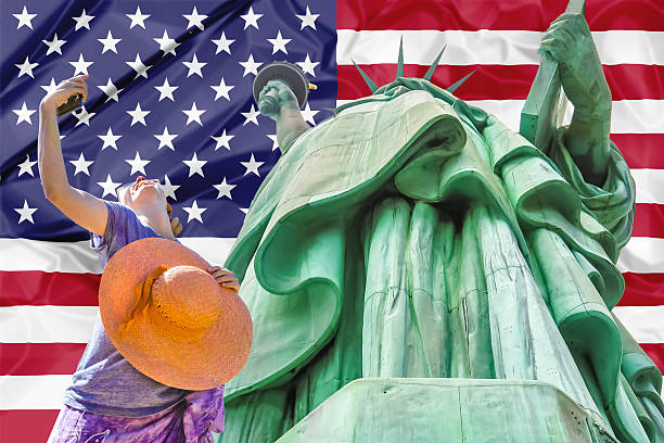 istock Statue of Liberty with american flag 615490992
