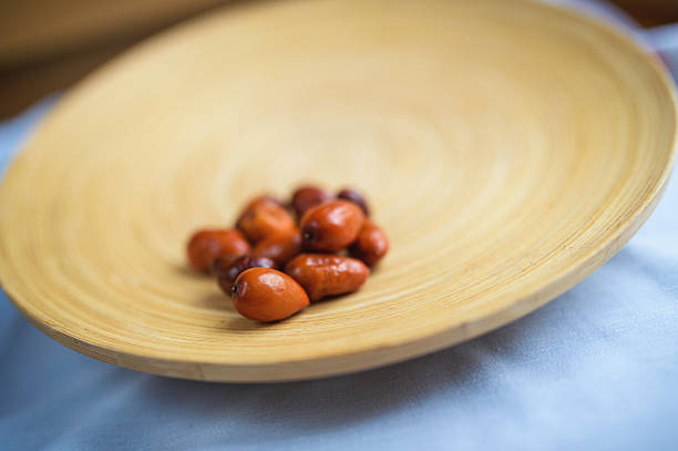 Delicious Ziziphus jujuba on a wooden plate, commonly called jujube or jujuba, red date, Chinese date, Korean date, or Indian date is a species of Ziziphus in the buckthorn family (Rhamnaceae). It is used primarily as a shade tree that also bears fruit.