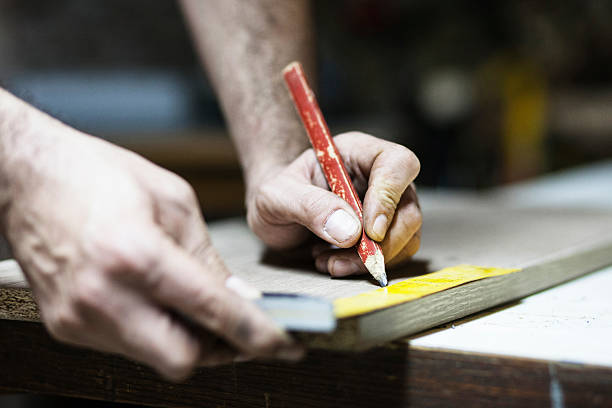 istock Drawing with construction pencil on wood and measuring tool 615492956