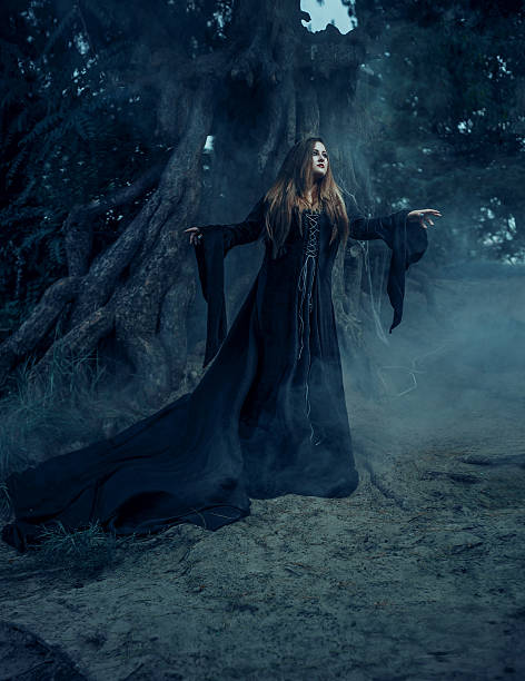 istock Wicked witch in a long vintage dress 615498756
