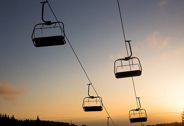istock Chair ski lift in winter sunset 615498780