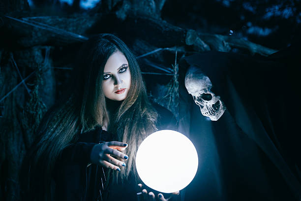 istock Piercing gaze witch, casts a spell over the crystal 615498976