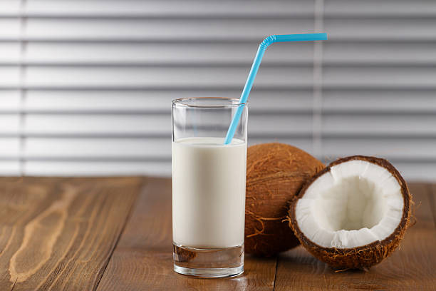 istock coconut milk and fresh coconuts on old wooden table 615503328