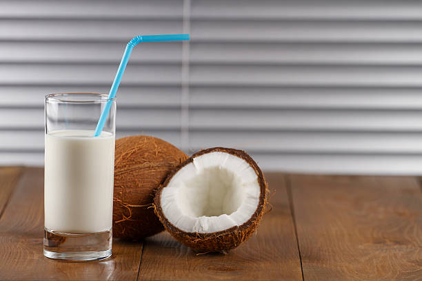 istock coconut milk and fresh coconuts on old wooden table 615503378