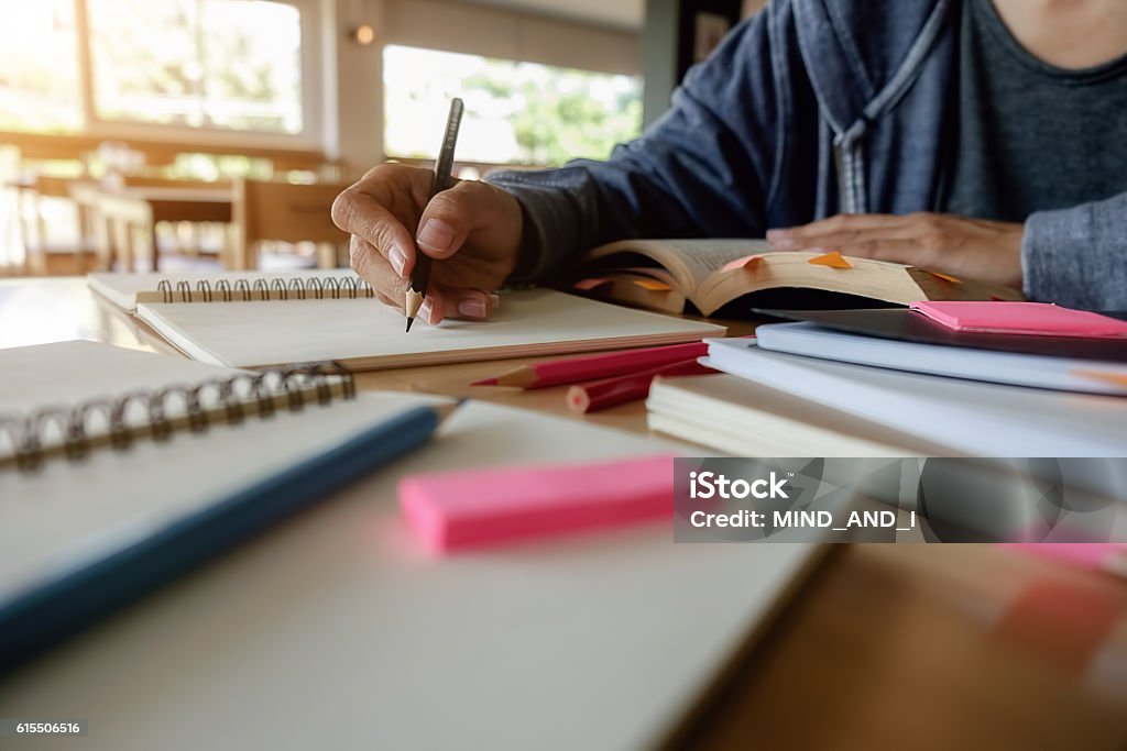 Education concept Education concept. Close up of student studies accessories with students discussing their subject on book or textbooks background. Textbook Stock Photo