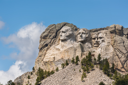 Side view of public monument Mount Rushmore with sunlight