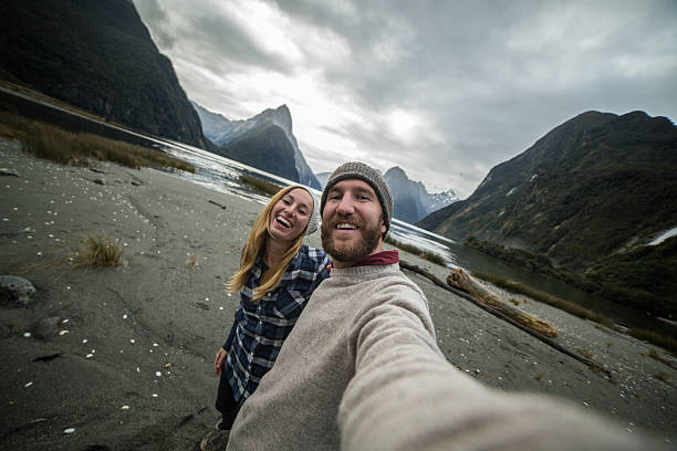 istock Young couple take selfie on mountain background 615508938