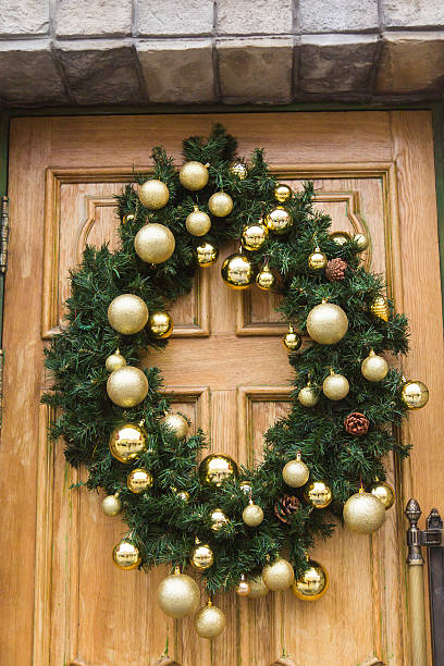 istock Christmas wreath with baubles and cones on a door. 615509442