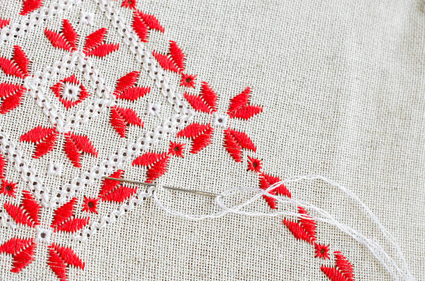 istock Embroidery  by red and white threads. Embroidery texture flat stitch. 615512334