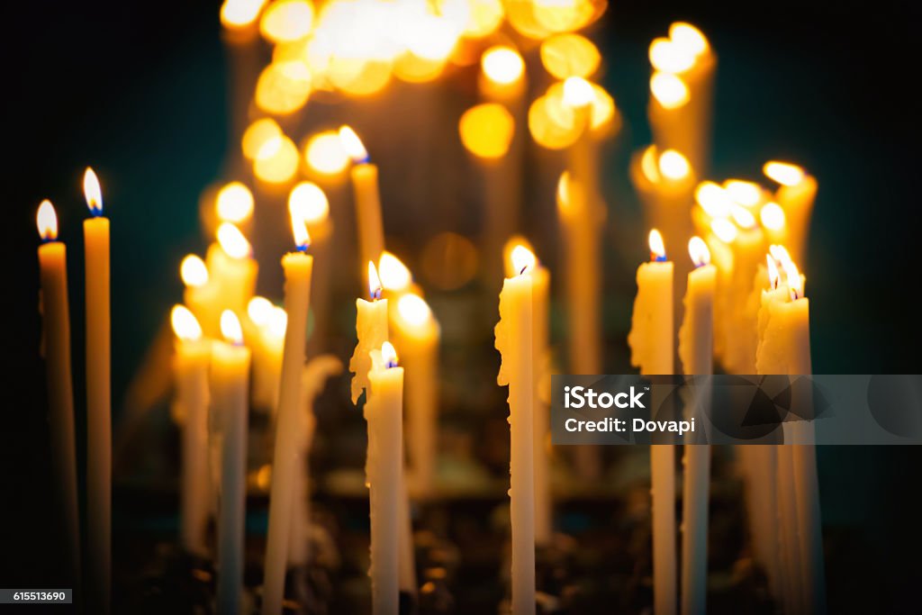 Candles in the church Light of candles in the church on the black background Candle Stock Photo