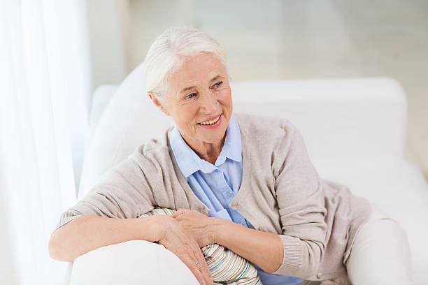 istock happy senior woman face at home 615514110