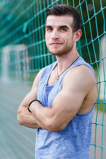 istock Smiling athletic instructor in sporty t-shirt looking at camera 615515196
