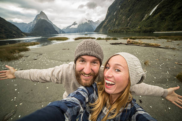 istock One young couple take selfie portrait with mountain landscape 615515916