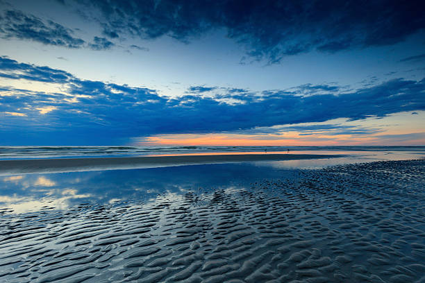 moody seascape and sunset along the Dutch coast; The Hague, Netherlands