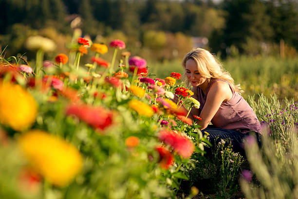 Adult female smelling wildflowers on a fall day