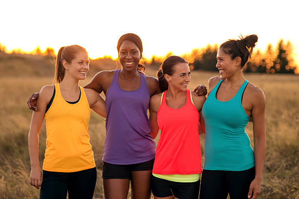 istock Diverse group of female athletes with arms around each other 615520164