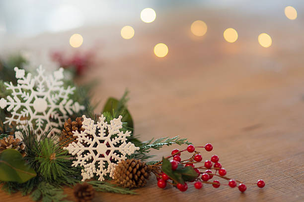 istock Holiday table decorations with snowflakes, pinecones, ribbon, and holly berries 615521448