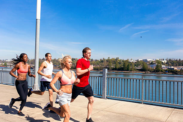 istock Diverse group of co-ed athletes running in an urban environment 615521848