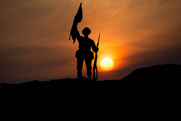 istock Sunset with silhouette of a soldier and flag copy space 615523702