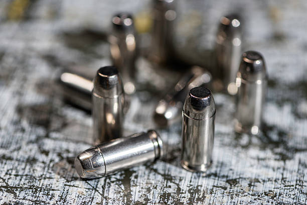 Ammunition Ammunition standing up and laying down. Silver Bullet stock pictures, royalty-free photos & images