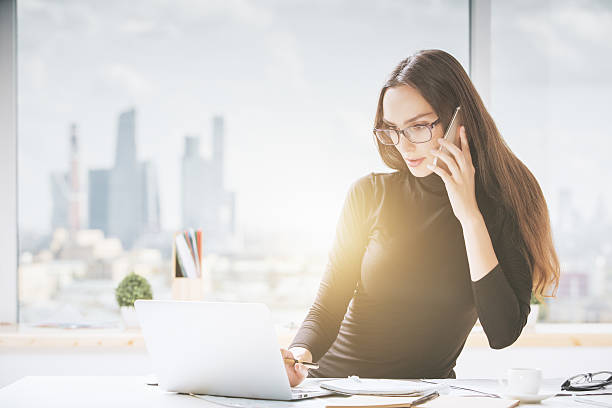istock Beautiful young woman in office 615594826