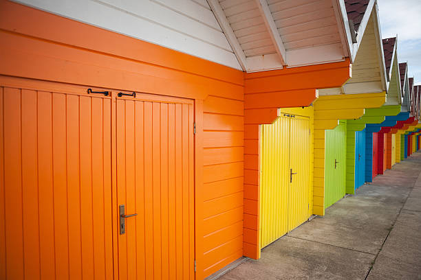 istock Row of bright coloured beach huts. 615596008