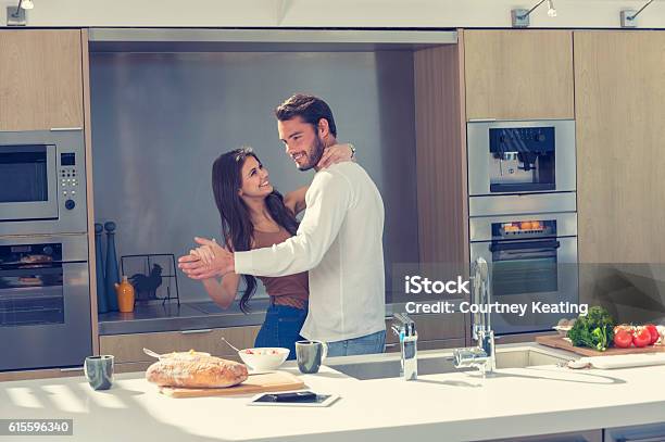 Couple Playfully Dancing In The Kitchen Stock Photo - Download Image Now - Couple - Relationship, Kitchen, Dancing